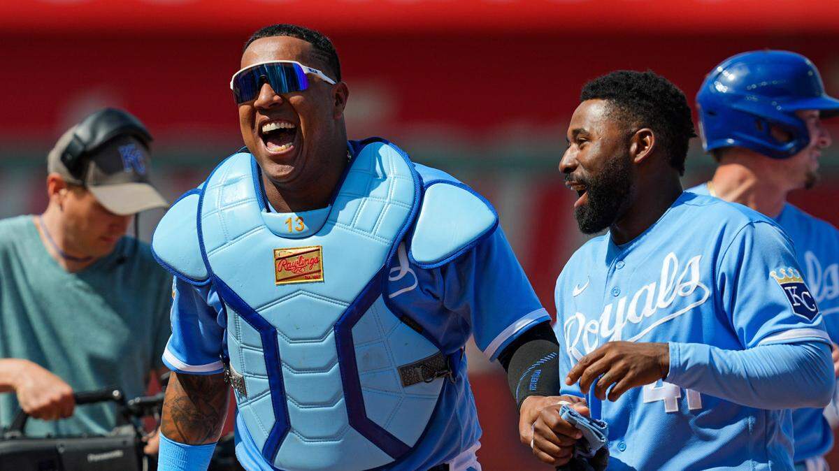 Kansas City Royals catcher Salvador Perez (13) and right fielder Jackie Bradley Jr. (41) celebrate after defeating the Washington Nationals at Kauffman Stadium on May 28, 2023.
