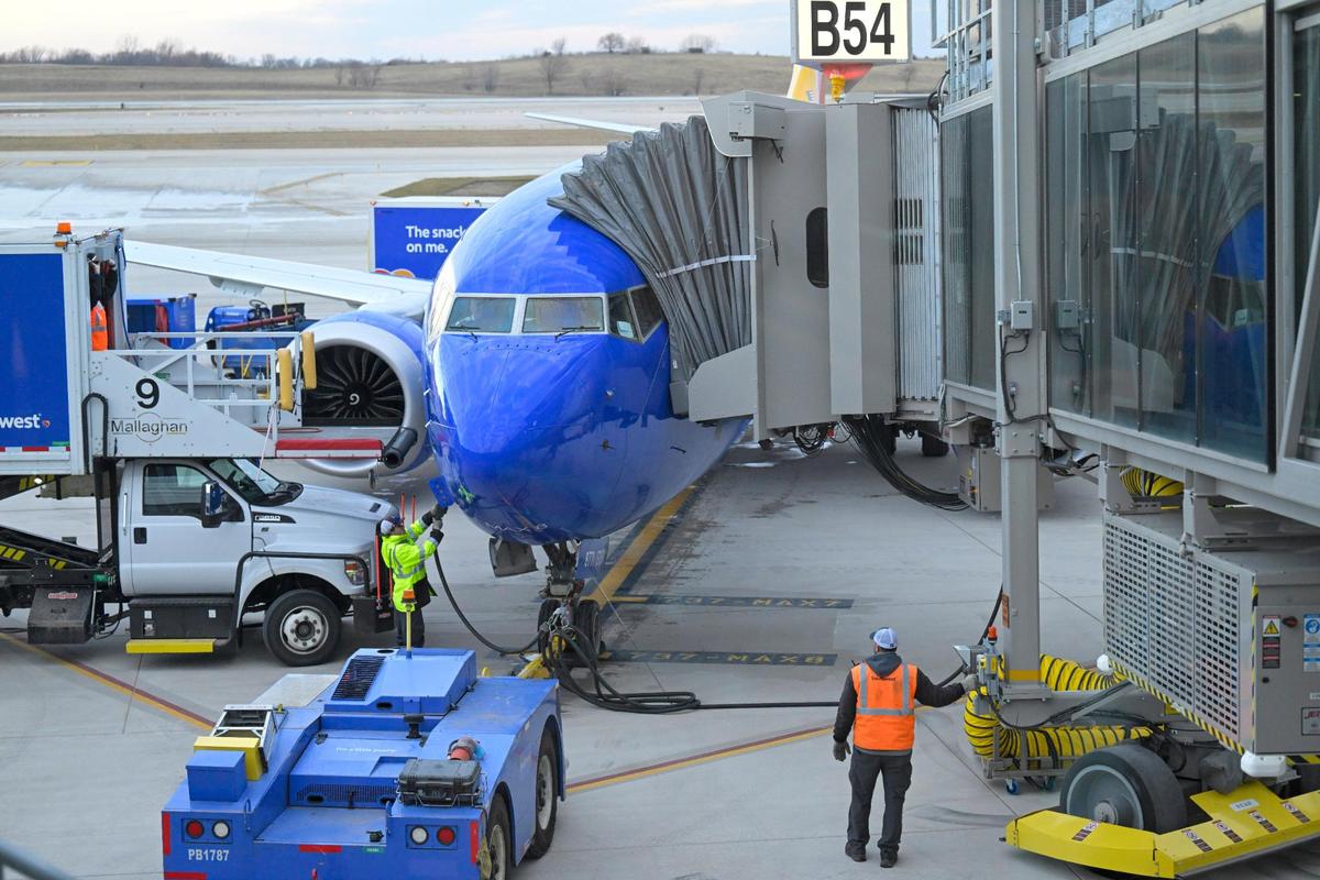 Ramp crews waited to unload the Southwest Airlines plane, which flew the first flight into the new $1.5 billion single terminal, on Tuesday, Feb. 28, 2022, at Kansas City International Airport.