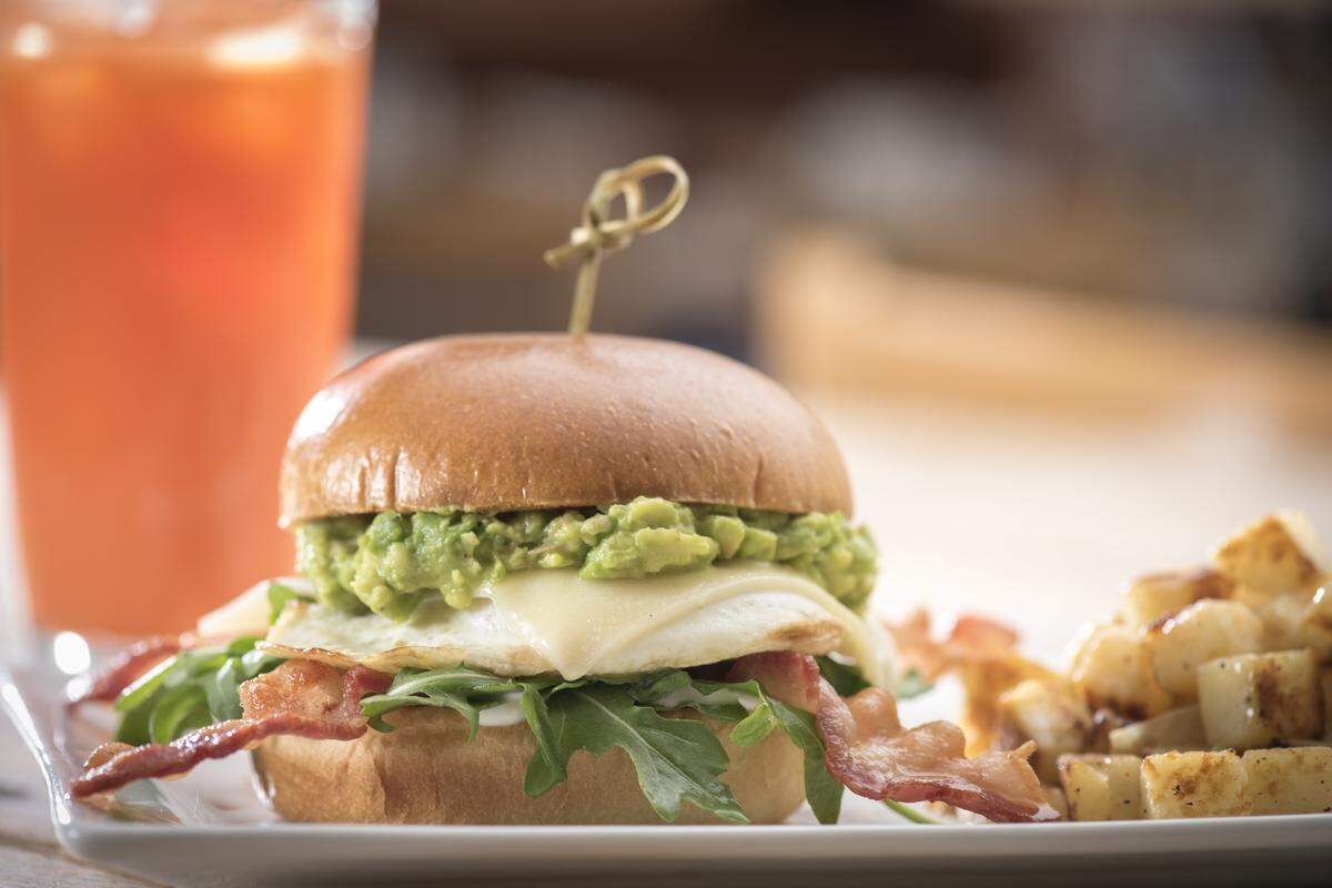 First Watch’s Elevated Egg Sandwich is an over-easy cage-free egg with bacon, Gruyere cheese, fresh smashed avocado, mayonnaise-and-lemon dressed arugula on a brioche bun.