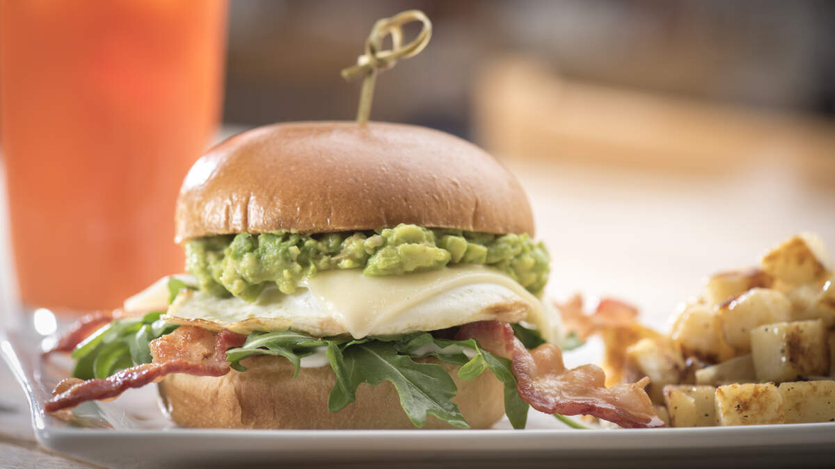 First Watch's Elevated Egg Sandwich is an over-easy cage-free egg with bacon, Gruyere cheese, fresh smashed avocado, mayonnaise-and-lemon dressed arugula on a brioche bun.
