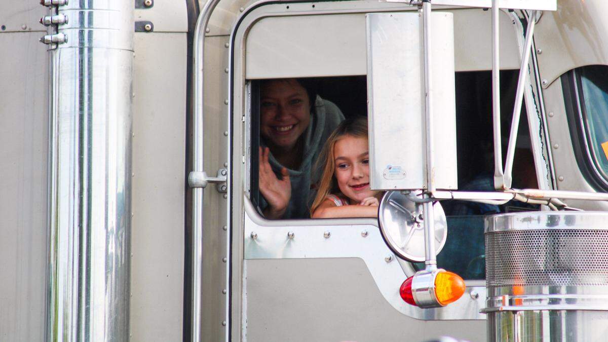 Parade participants wave toward Tucker Langford, a 3-year-old battling terminal illness, on Saturday, Oct. 11, 2025.