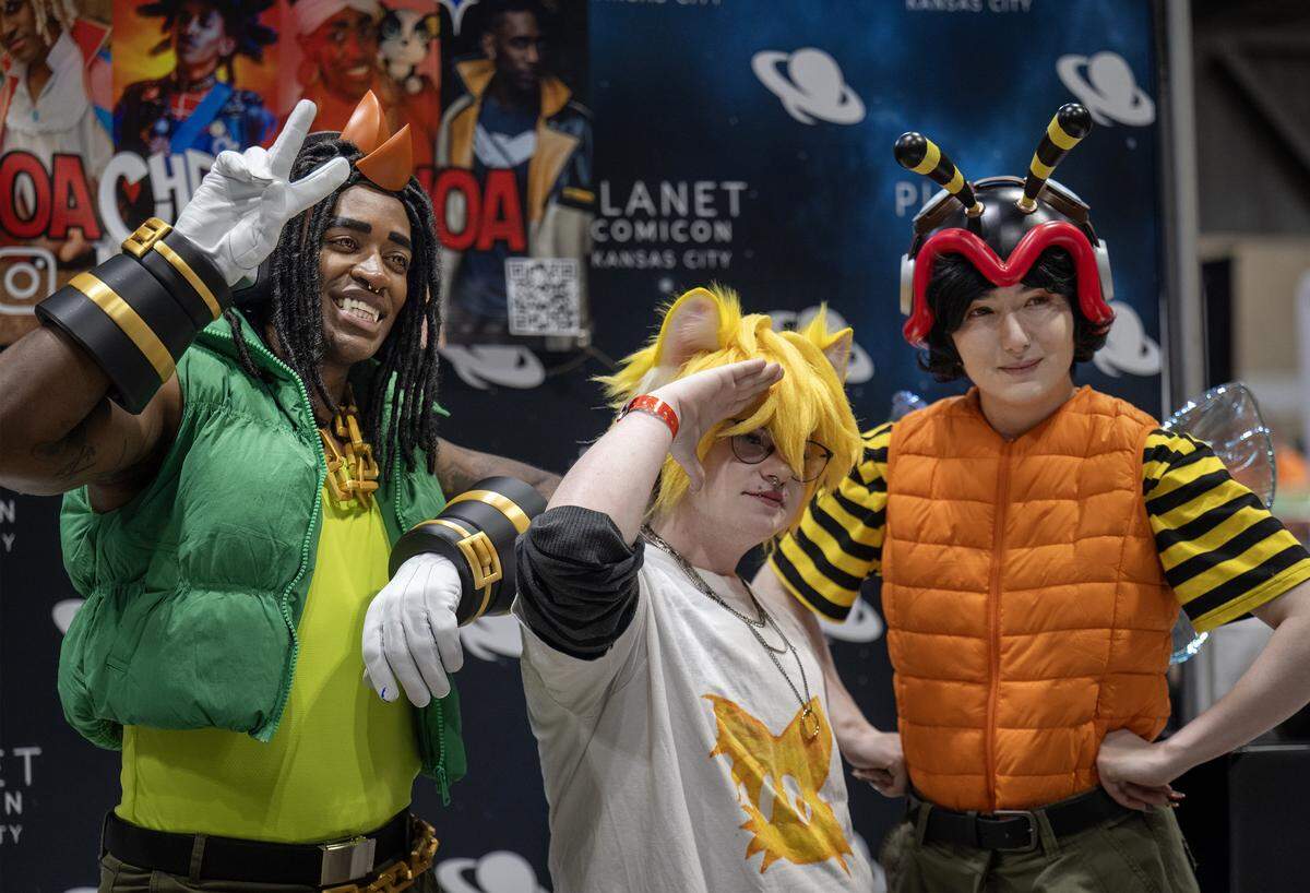 Cosplayers Chris Williams as WhoaChrisWhoa, left, and Charmy Bee, right, pose with Grave Sitznan as Miles "Tails" Prower from Sonic the Hedgehog during Planet Comicon Kansas City on Sunday, March 29, 2026. 
