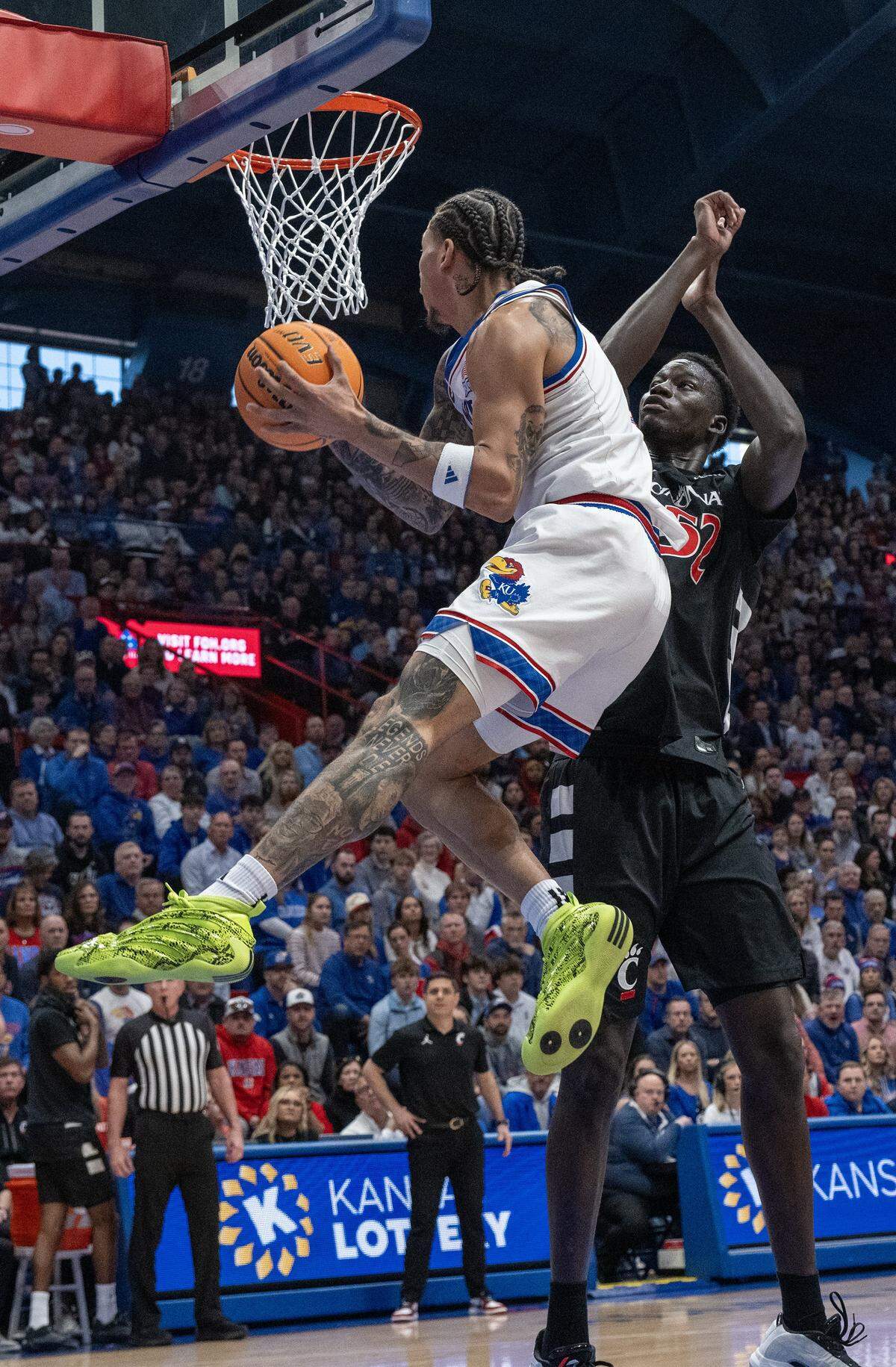 Kansas Jayhawks guard Tre White (3) goes up for a shot as Cincinnati Bearcats center Moustapha Thiam (52) defends in the first half Allen Fieldhouse on Saturday, Feb. 21, 2026, in Lawrence, Kansas.