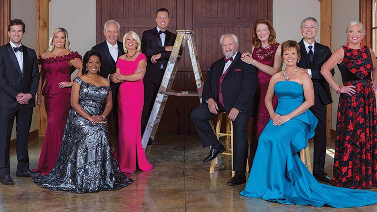 From left to right: Chris Rosburg in a Houndstooth tuxedo; Jennifer Matney in a John Paul Ataker gown available at Natalie M. and The Gown Gallery; Nicole Jacobs-Silvey in a John Paul Ataker gown from The Gown Gallery; Greg Graves in a white-tie tuxedo from Pinstripes; Deanna Graves in a Teri Jon gown from The Gown Gallery; Darren Prenger in a Houndstooth tuxedo; Terry Ward in a Pinstripes tuxedo; Linda Ward in an Alex Evenings gown from Sincerely Susan; Cheryl Reinhardt in a John Paul Ataker gown from Natalie M.; Joe Jacobs III in a Pinstripes tuxedo and Carol Barnett in a Tahari gown from Sincerely Susan.