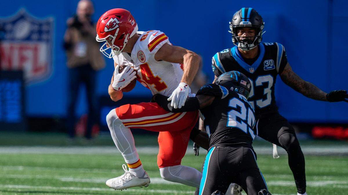 Kansas City Chiefs wide receiver Justin Watson (84) is tackled by Carolina Panthers safety Xavier Woods (25) during the second quarter at Bank of America Stadium.