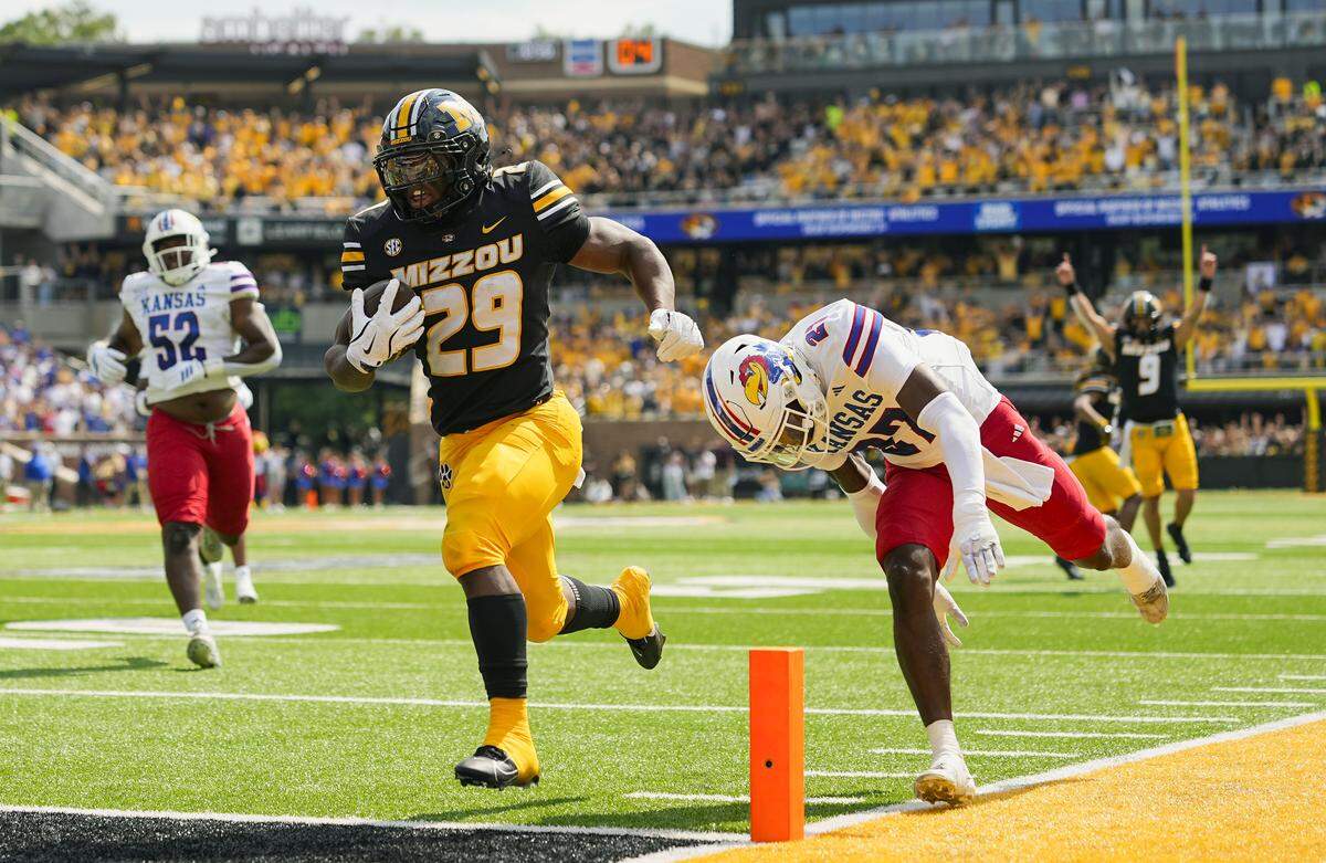 Missouri Tigers running back Ahmad Hardy (29) runs for a touchdown against Kansas Jayhawks safety Taylor Davis (27) during the first half at Faurot Field at Memorial Stadium on Sept. 6, 2025.