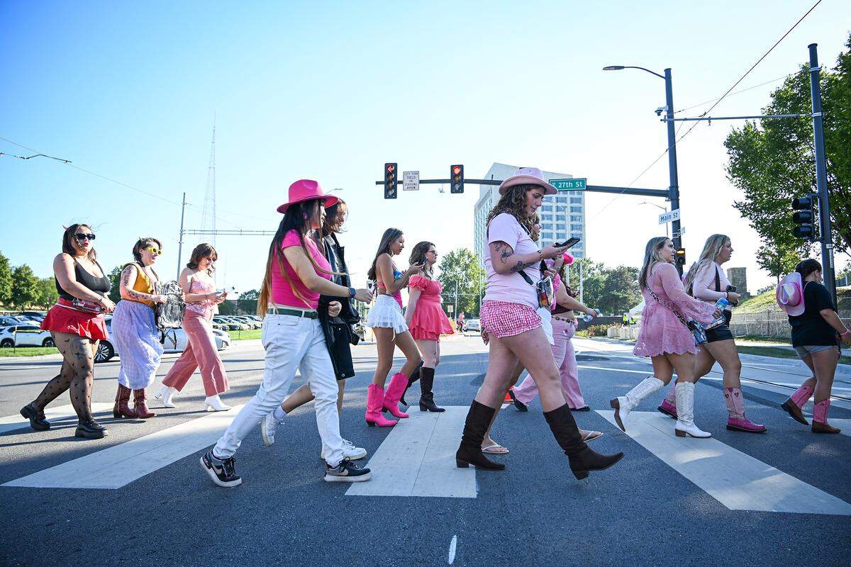 Fans cross Mains Street on their way to attend the Chappell Roan concert on Saturday, Oct. 4, 2025, at the National WWI Museum and Memorial in Kansas City.