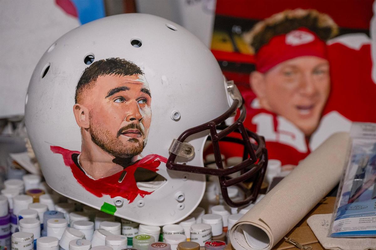 Self-taught artist Jeff Parson is working on a helmet emblazoned with an image of Kansas City Chiefs tight end Travis Kelce. “It’s difficult to paint on a round surface,” he said of the helmet on Wednesday in his basement studio in Riverside, Missouri. A painting of Chiefs quarterback Patrick Mahomes is also a work in progress.