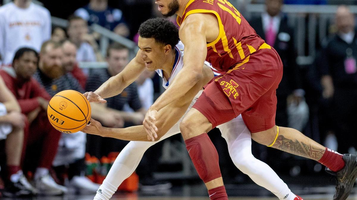 Iowa State guard Jaren Holmes (13) fouls Kansas guard Kevin McCullar Jr. (15) during the Big 12 Tournament semifinal round on Friday, March 10, 2023, in Kansas City.