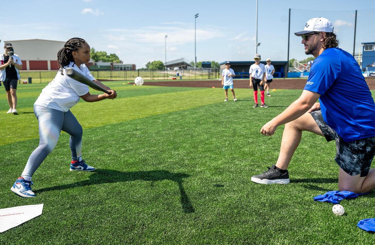 Kansas City Royals first baseman Vinnie Pasquantino tosses a whiffle ball for batting practice as he coaches a young player during the Vinnie Pasquantino Baseball ProCamp at Grandview High School on Thursday, July 10, 2025, in Grandview, Missouri.