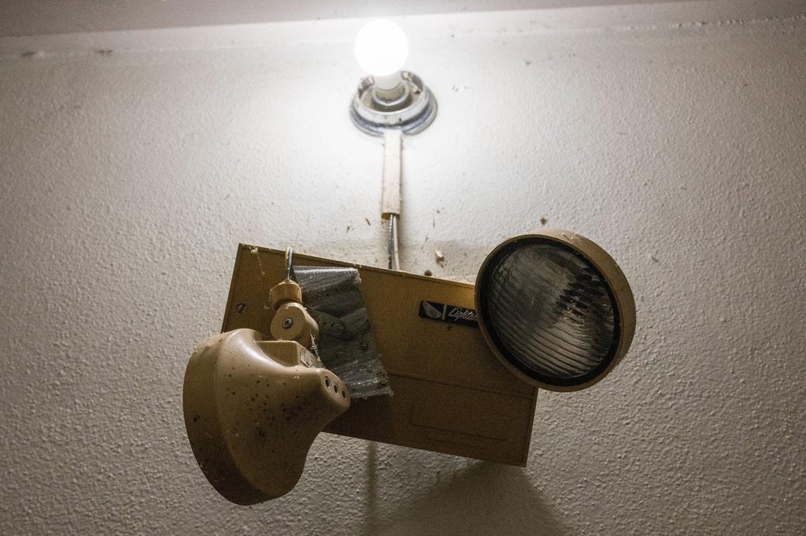 A broken light fixture hangs off the wall at Quality Hill Towers, an apartment complex in Kansas City. The complex, owned by Sentinel Real Estate Corporation, houses an estimated 250 residents. Over 100 tenants formed a union to address living conditions.