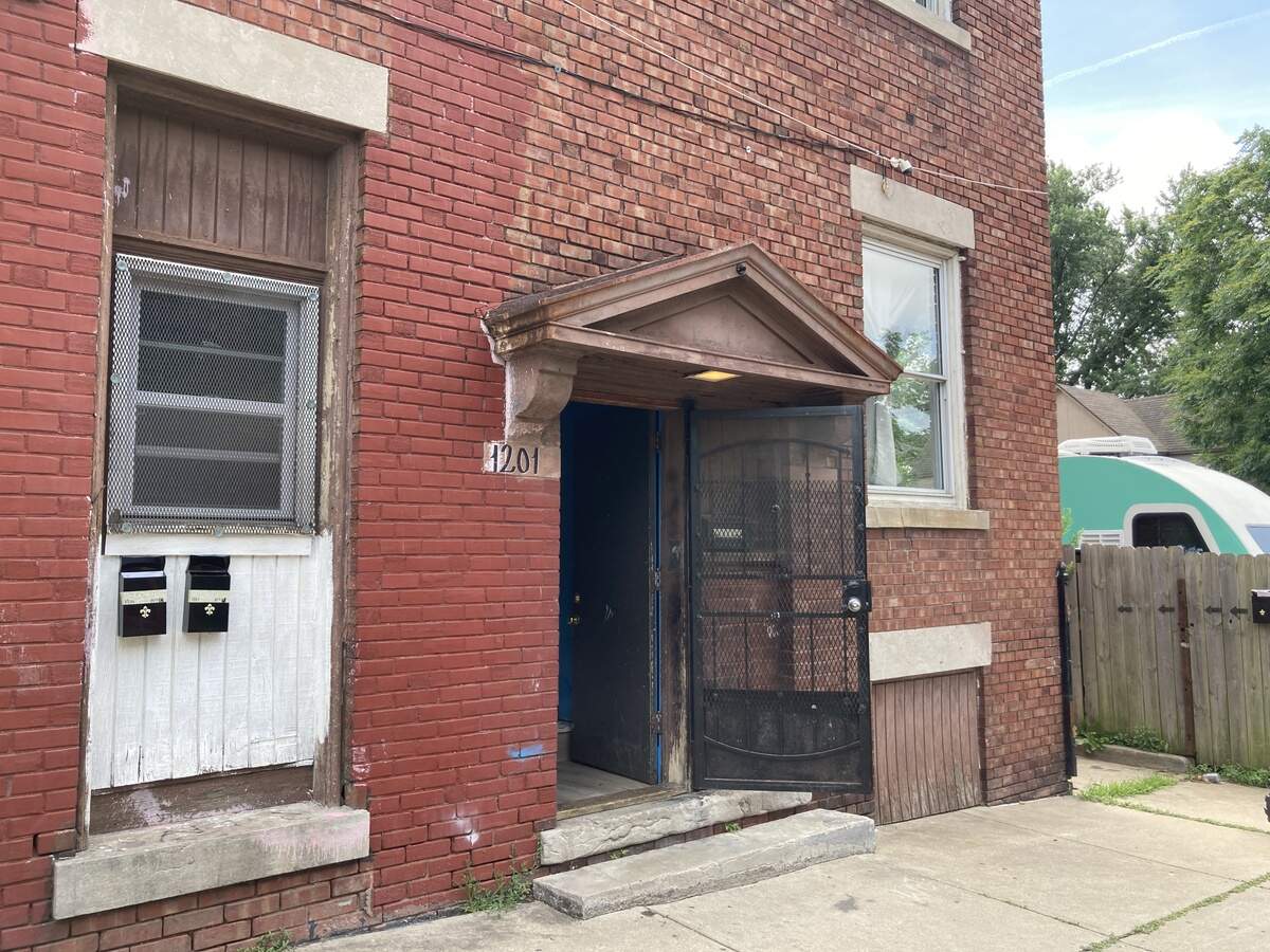 Gunfire broke out Monday evening, June 1, inside an upstairs apartment in the building on the corner of East 12th Street and Askew Avenue. One man was killed. His son was seriously injured.