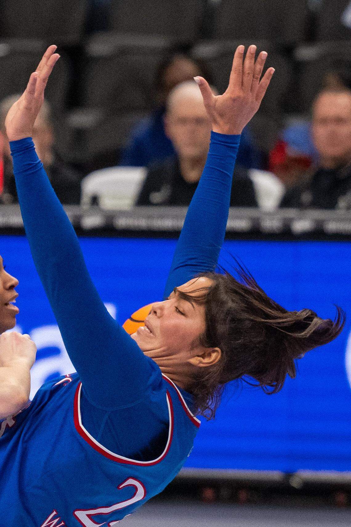 Kansas Jayhawks forward Regan Williams (24) absorbs contact on a screen in the second half of the Jayhawks first round game of the Big 12 Women's Basketball Tournament on Thursday, March 5, 2026, at T-Mobile Center.