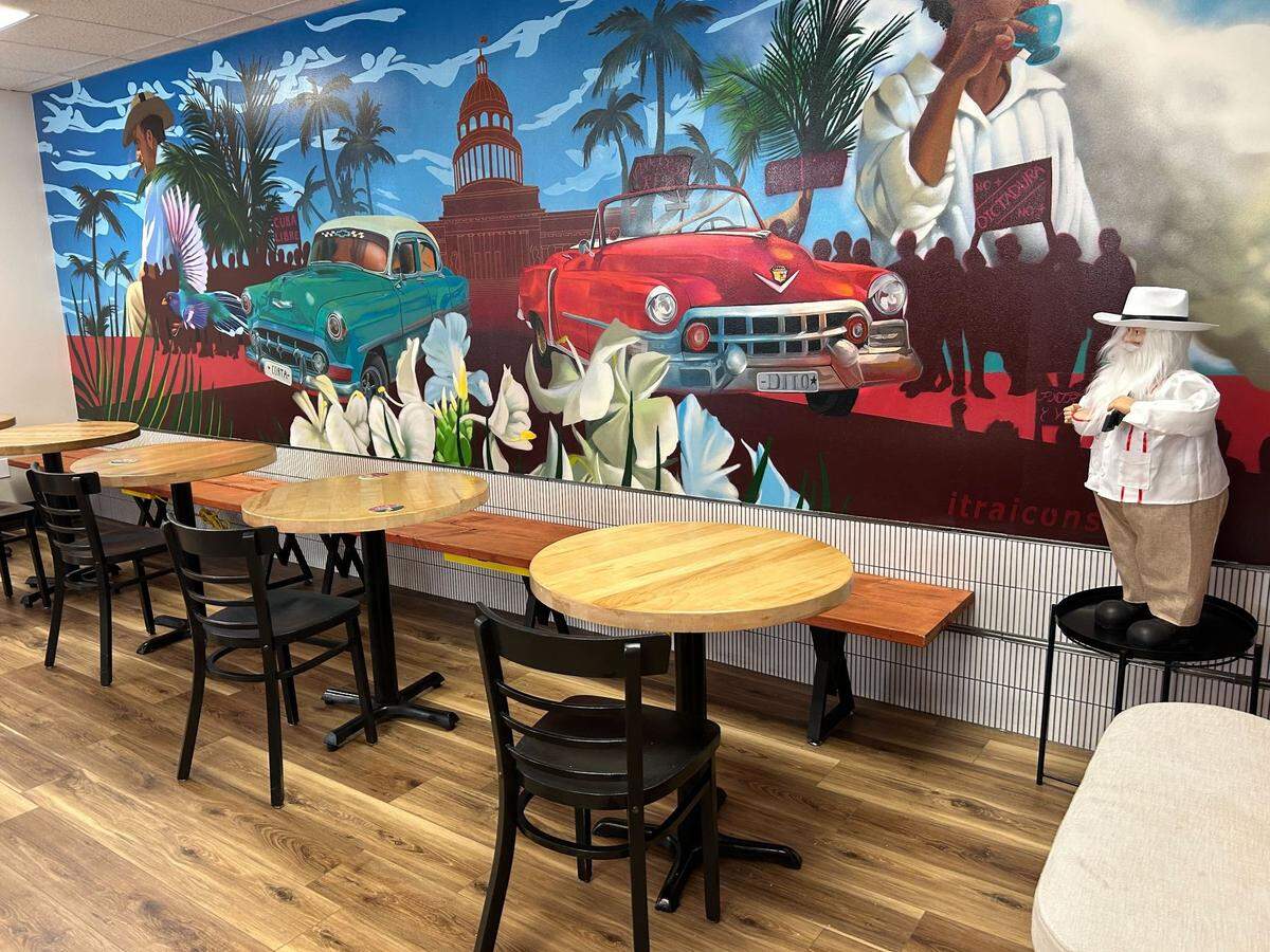 It-Ra Icons painted the mural inside Cortadito, which depicts Cuba’s natural beauty and political unrest.