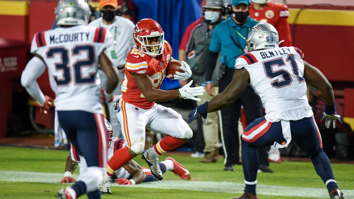 Kansas City Chiefs running back Clyde Edwards-Helaire (25) rushed against New England Patriots safety Devin McCourty (32) linebacker Ja’Whaun Bentley (51) during the second-half game action against the New England Patriots at Arrowhead Stadium on Monday, Oct. 5, 2020, in Kansas City. The Chiefs defeated the Patriots, 26-10.