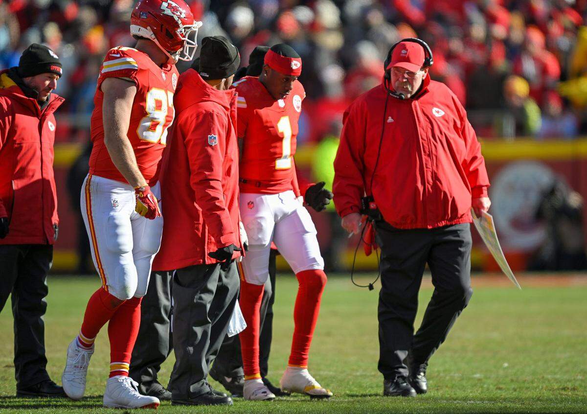 Kansas City Chiefs head coach Andy Reid checks on Kansas City Chiefs wide receiver Xavier Worthy (1) after he was injured in the first half against the LA Chargers at GEHA Field at Arrowhead Stadium on Sunday, Dec. 14, 2025.