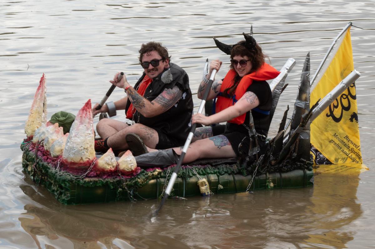 Nick Lewz and Samantha ‘Wolf’ Wolfskill paddle away from Kaw Point Saturday during the Kawsmouth River Carnival.