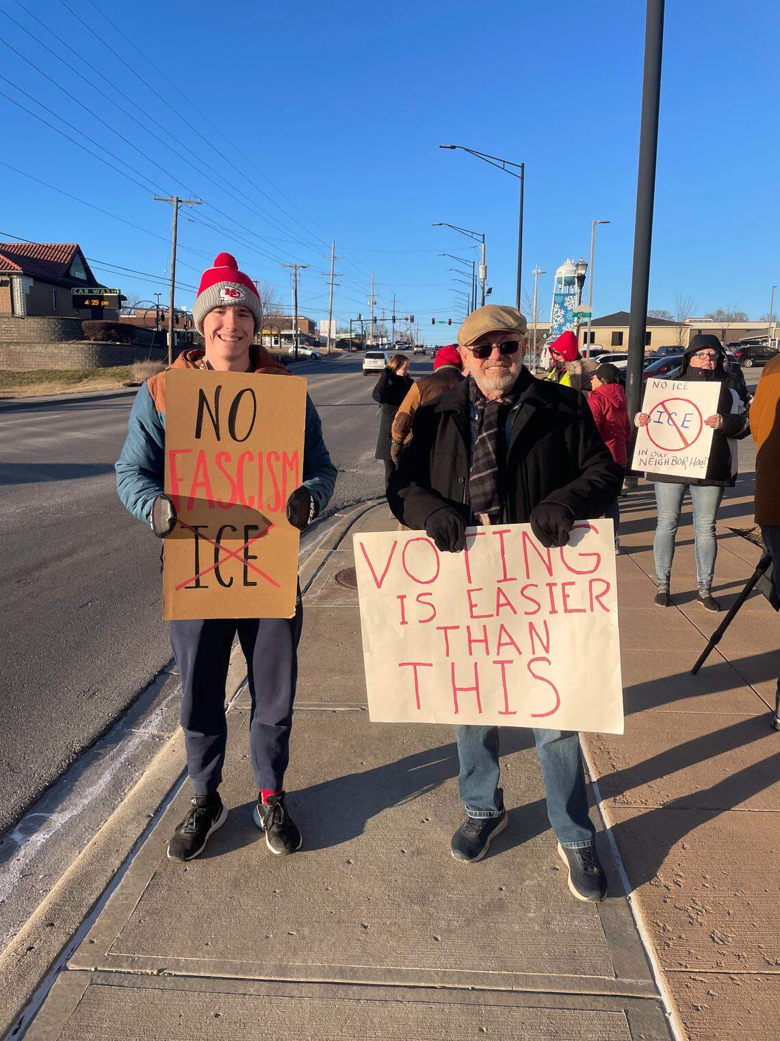 Protesters hold signs reading “No Facism” and “Voting Is Easier Than This” during an anti-ICE protest on the afternoon of Jan. 19, 2026, in Gladstone.