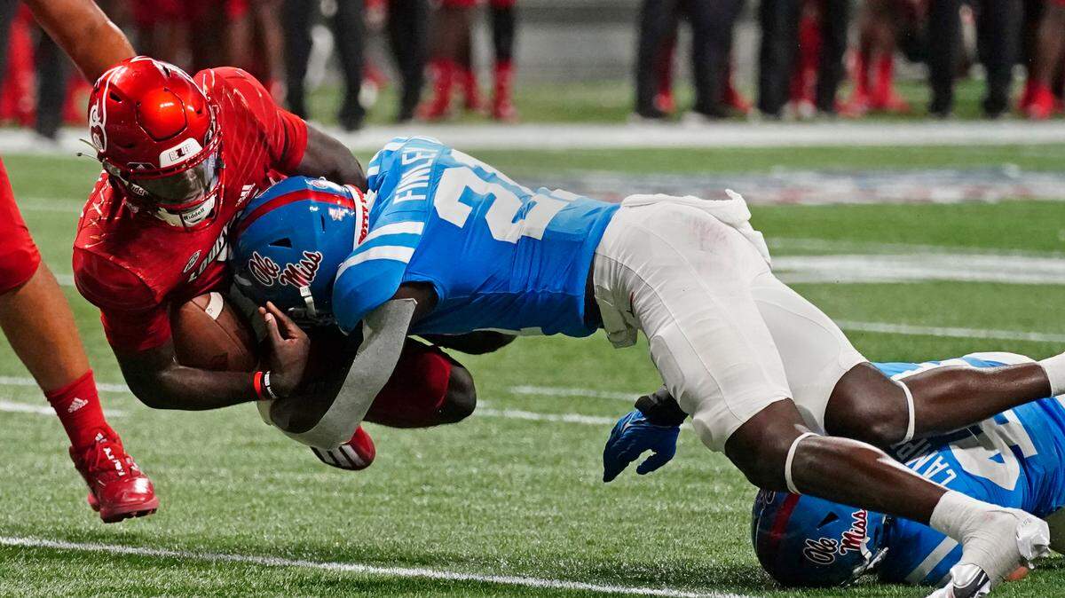 Louisville quarterback Malik Cunningham (3) is brought down by Mississippi defensive back AJ Finley (21) during the second half of an NCAA college football game Monday, Sept. 6, 2021, in Atlanta. (AP Photo/John Bazemore)