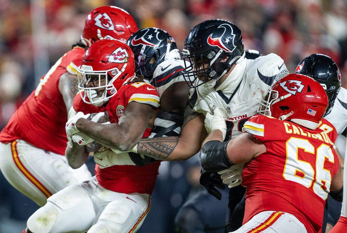 Kansas City Chiefs running back Kareem Hunt (29) is stopped by the Houston Texans defense in the second half on Sunday, Dec. 7, 2025, at GEHA Field at Arrowhead Stadium in Kansas City. 