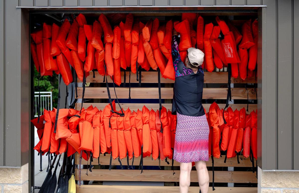 Rebecca Friedman returns her life jacket to a new storage facility at the newly-renovated Shawnee Mission Park Marina on Wednesday, July 12, 2023, in Shawnee, Kan.
