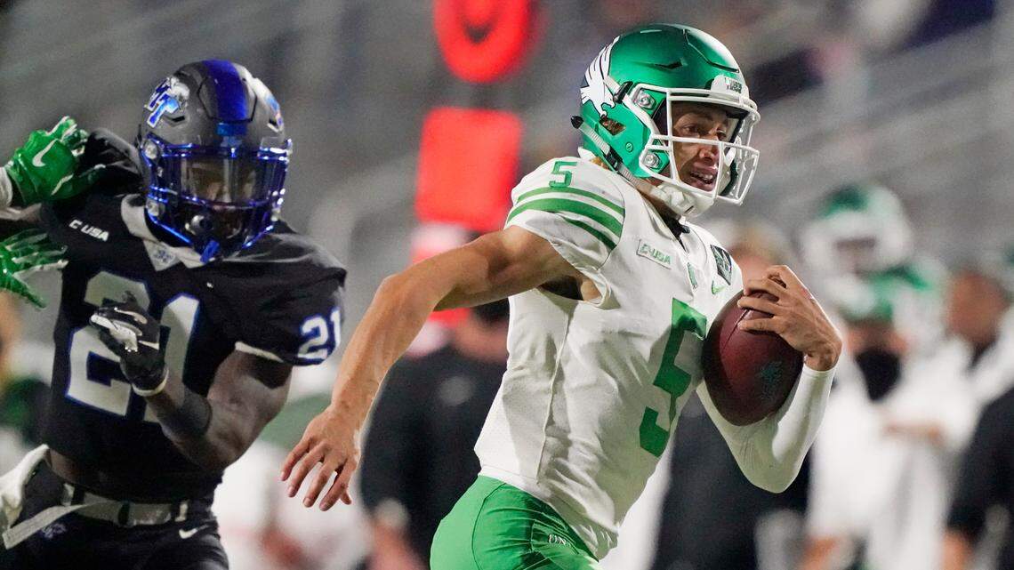 North Texas quarterback Jason Bean (5) scrambles past Middle Tennessee cornerback Kenneth Major (21) in the second half of an NCAA college football game Saturday, Oct. 17, 2020, in Murfreesboro, Tenn. (AP Photo/Mark Humphrey)