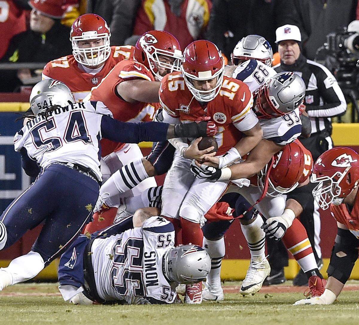 Chiefs quarterback Patrick Mahomes is sacked by a hoard of New England Patriots defenders in the third quarter Sunday night.