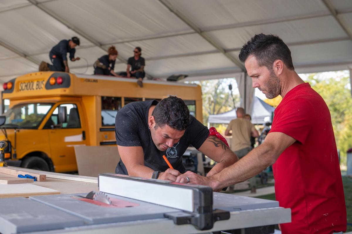 Igor Tomas, left and Travis Dean worked together Tuesday to measure out the exact amount of wood they would need for paneling inside an RV they’re renovating for the reality show “Gutted” at Camp Branch in Smithville.