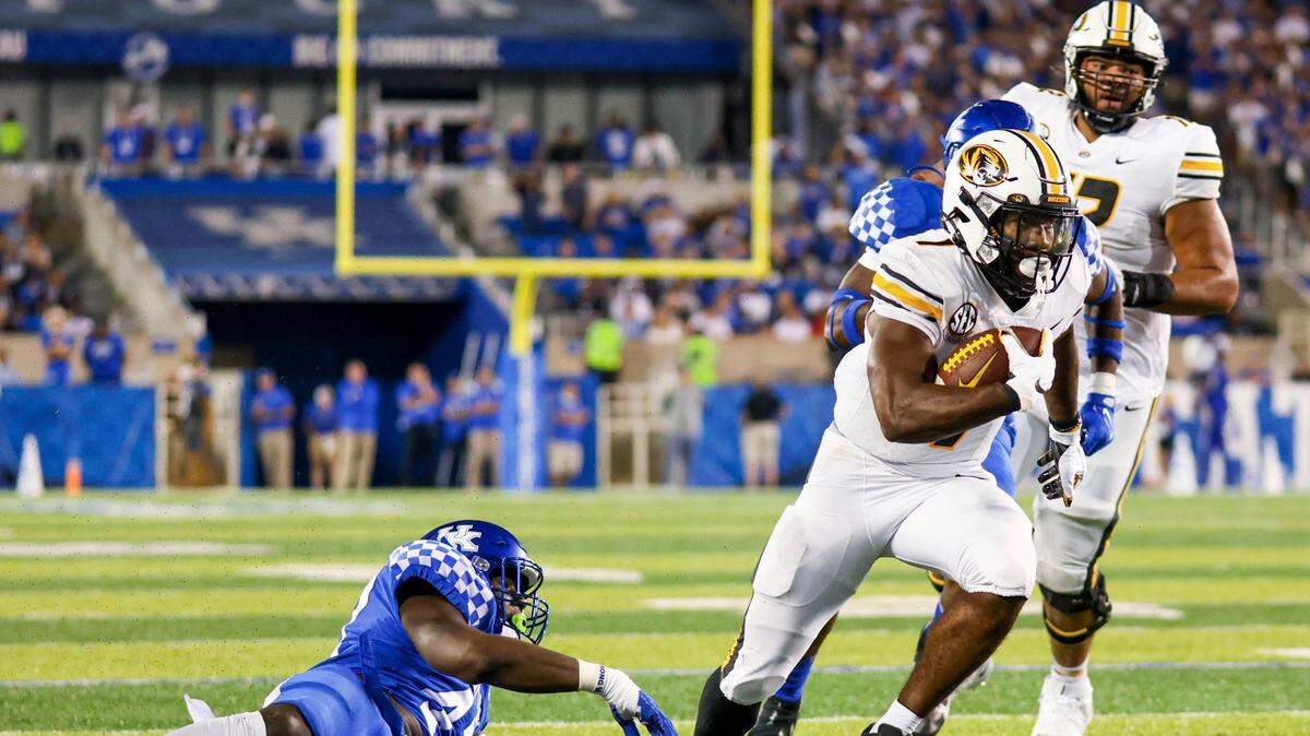 Missouri running back Tyler Badie (right) runs toward the end zone during the second half against Kentucky in Lexington, Ky., Saturday, Sept. 11, 2021.