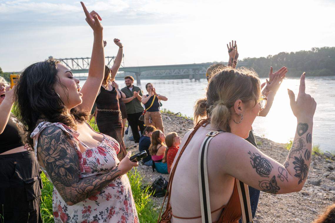 Participants of the initial meeting of the Scream Club, scream while they celebrate collective wins on the banks of the Missouri River.