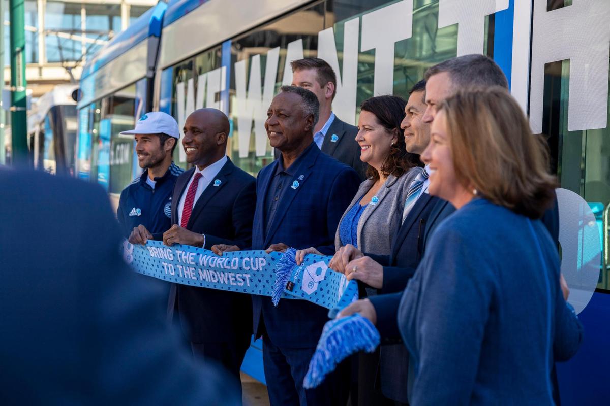 Kansas City community leaders posed for photos to celebrate a newly wrapped KC Streetcar promoting the city as an ideal host site for World Cup matches in 2026.