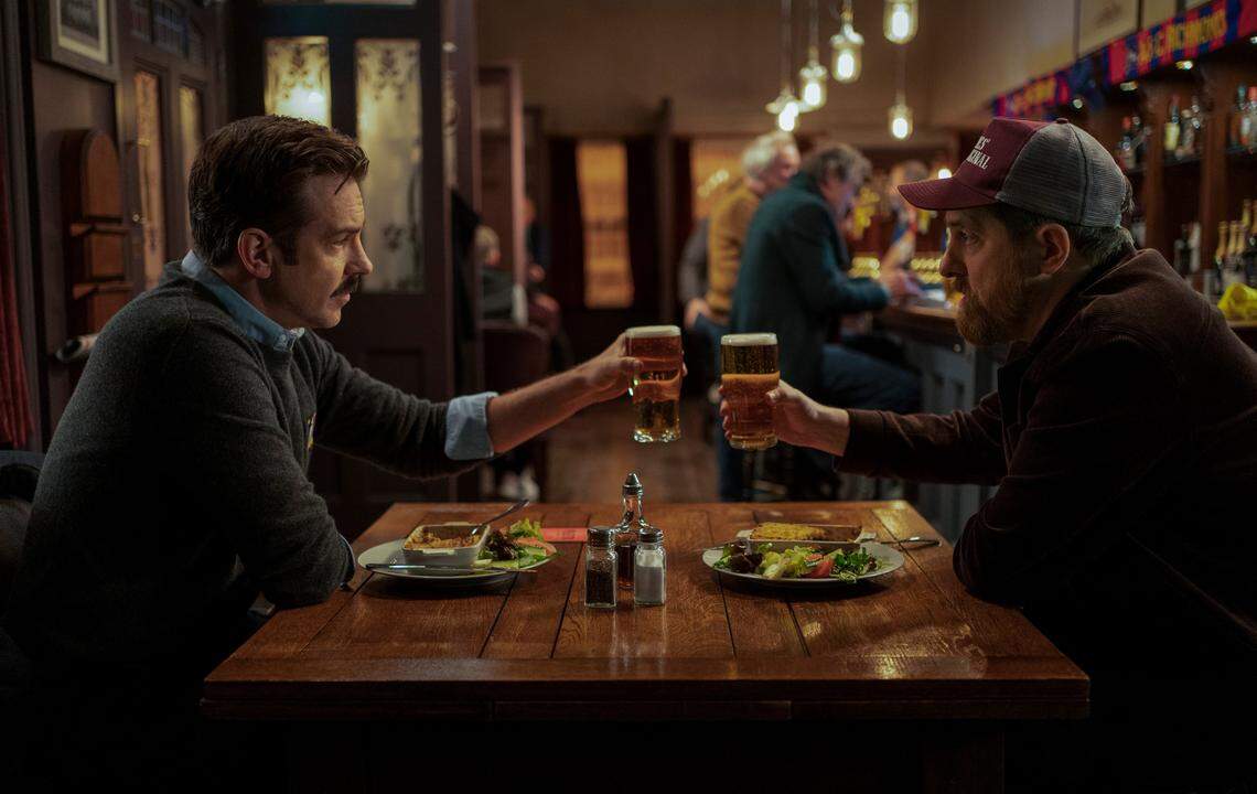 Ted Lasso (Jason Sudeikis, left) and Coach Beard (Brendan Hunt, who also co-writes and co-produces) share one of many pints in season two.