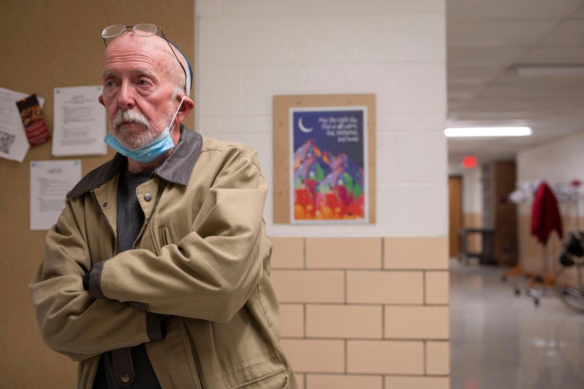 Bob Winner, speaks to a volunteer before eating dinner at Project 1020 winter shelter in Lenexa. Winner has been staying at Project 1020 after he was evicted from his apartment last year and left with no permanent home.