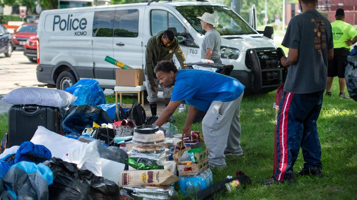 At Camp Sixx, a camp for people experiencing homelessness, some members of the camp readied their belongings as they waited for a Kansas City Area Transportation Authority bus to arrive to transport the members to another park after they were forced by police to leave the camp Sunday, July 19, 2021, at Southwest Trafficway and Westport Road in Kansas City.