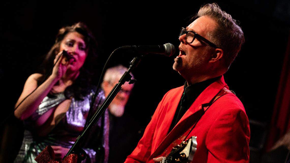 The David George Orchestra, including singer Shay Estes, left, and frontman David George, will perform original songs from his musical “Christmas Ain’t a Drag.”