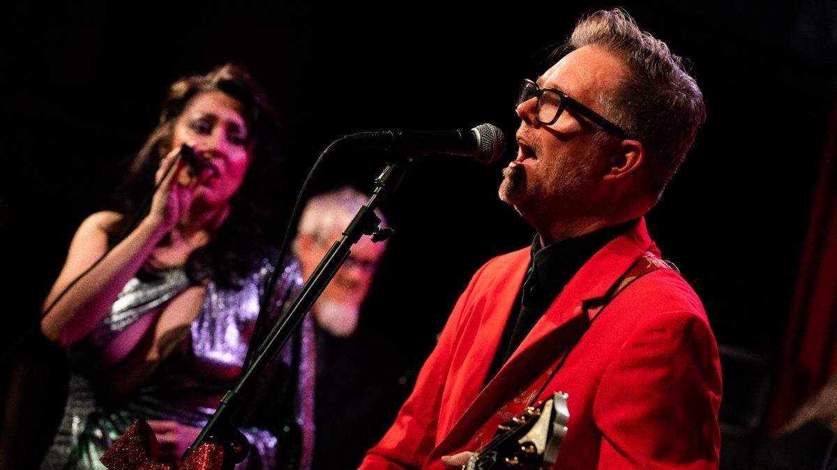 The David George Orchestra, including singer Shay Estes, left, and frontman David George, will perform original songs from his musical “Christmas Ain’t a Drag.”
