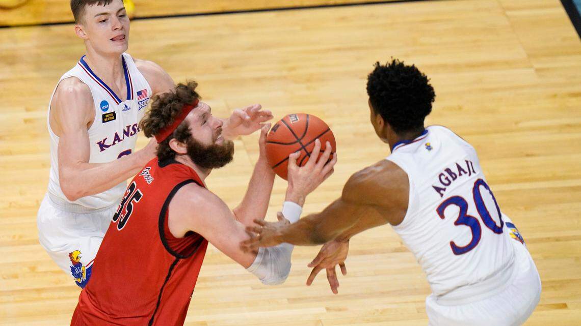 Eastern Washington forward Tanner Groves (35) is pressured by Kansas guard Christian Braun, left, and Kansas guard Ochai Agbaji (30) as he goes up for a shot during the second half of a first-round game in the NCAA college basketball tournament at Farmers Coliseum in Indianapolis, Saturday, March 20, 2021. (AP Photo/AJ Mast)