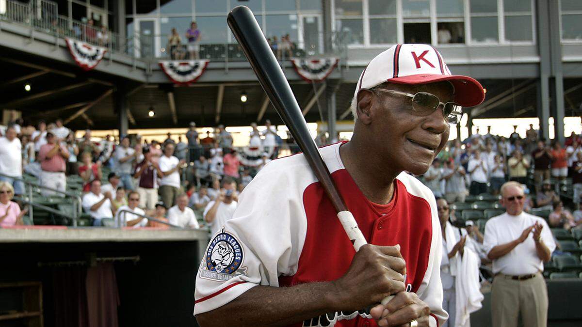 Buck O’Neil walks to the field as he is introduced before a minor league all-star game Tuesday, July 18, 2006, in Kansas City, Kansas.