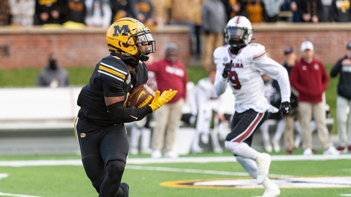 Missouri wide receiver Mookie Cooper, left, pulls in a touchdown pass in front of South Carolina defensive back Cam Smith, right, during the second quarter of an NCAA college football game Saturday, Nov. 13, 2021, in Columbia, Mo. (AP Photo/L.G. Patterson)