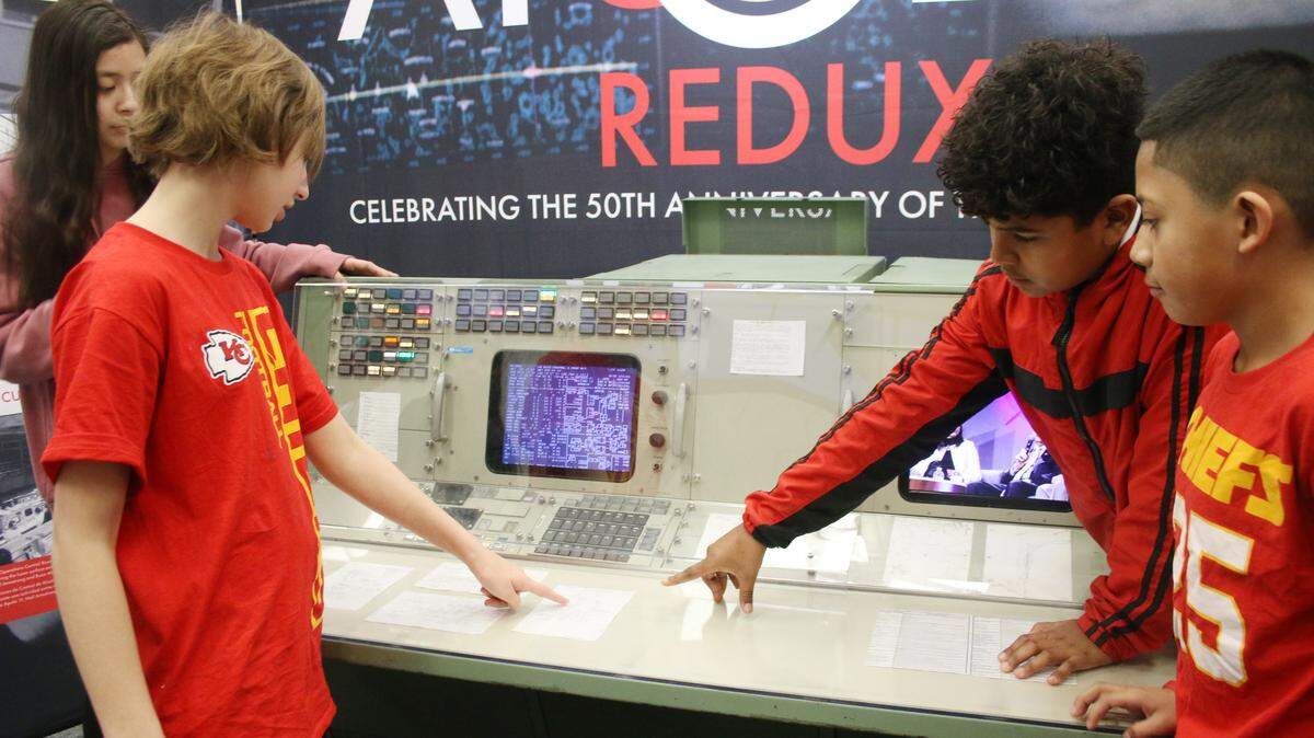 Oregon Trail Middle School students Yoselin Delafuente Valenzuela, Saoirse McCall, Estiven Suazo and Julio Becerra look at the screens and notes from NASA’s mission control dating back to the Apollo missions of the 1960s. The school hosted a traveling exhibit from the Cosmosphere in Hutchinson.