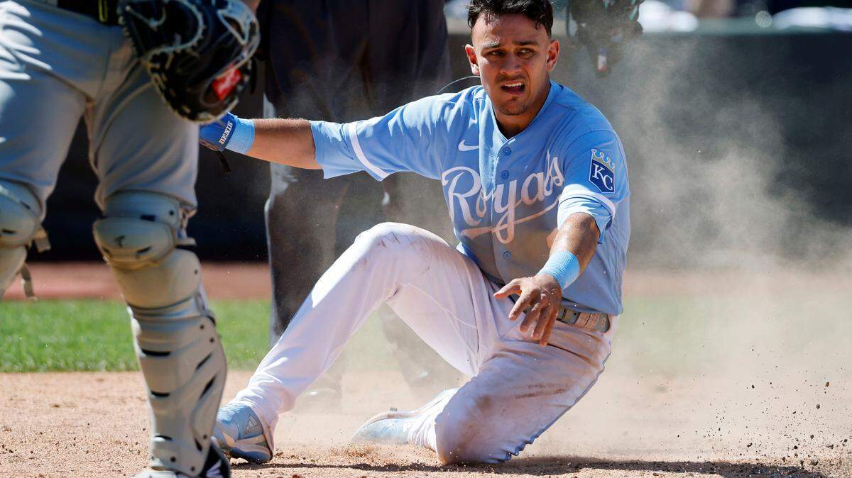 Kansas City Royals’ Nicky Lopez slides across home plate as he scores from third off an MJ Melendez single during the seventh inning of a baseball game against the Chicago White Sox in Kansas City, Mo., Thursday, Aug. 11, 2022. (AP Photo/Colin E. Braley)