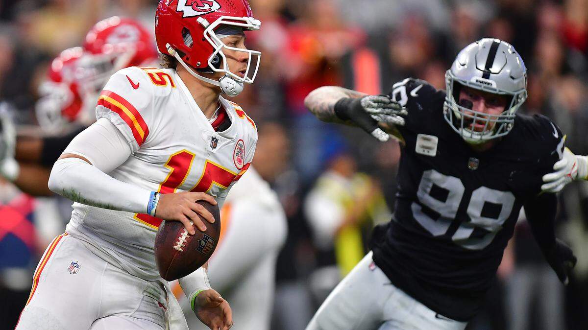 Jan 7, 2023; Paradise, Nevada, USA; Kansas City Chiefs quarterback Patrick Mahomes (15) runs the ball as Las Vegas Raiders defensive end Clelin Ferrell (99) moves in during the first half at Allegiant Stadium. Mandatory Credit: Gary A. Vasquez-USA TODAY Sports