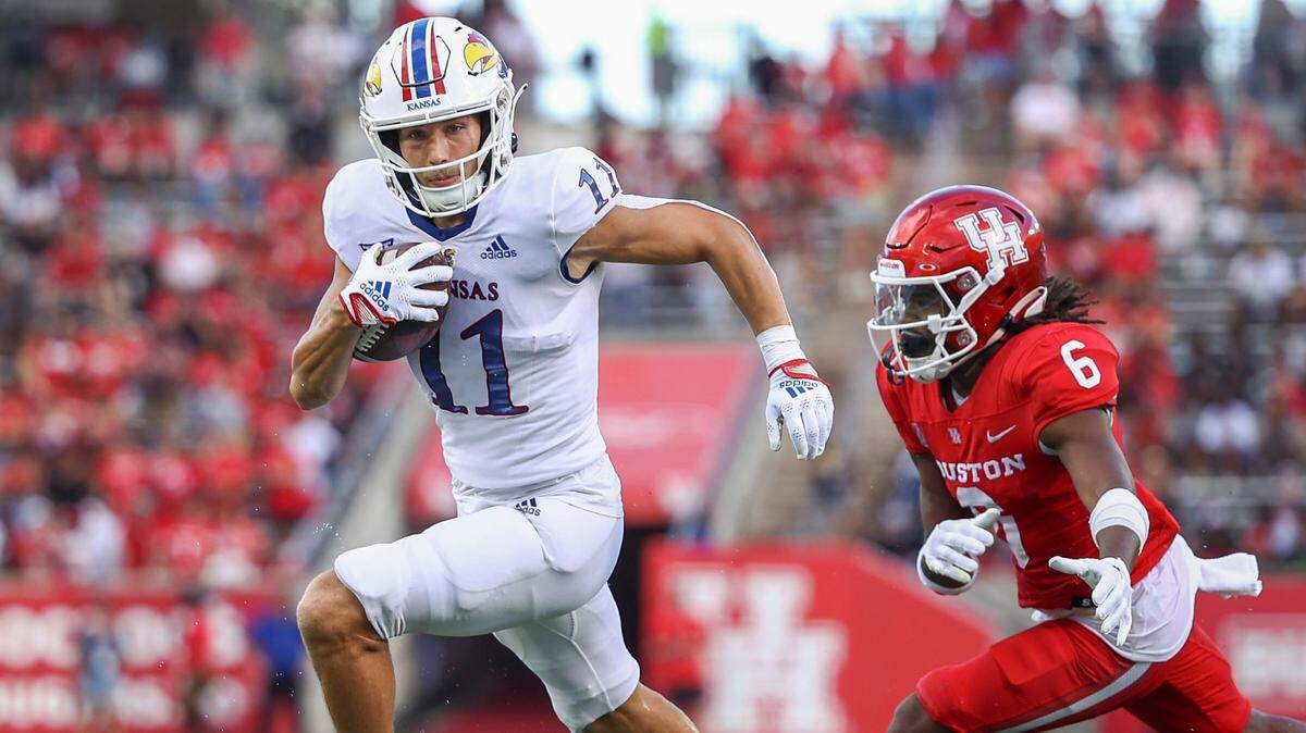 Kansas Jayhawks wide receiver Luke Grimm (11) runs with the ball and scores a touchdown as Houston Cougars defensive back Jayce Rogers (6) defends during the second quarter at TDECU Stadium on Sept. 17, 2022.