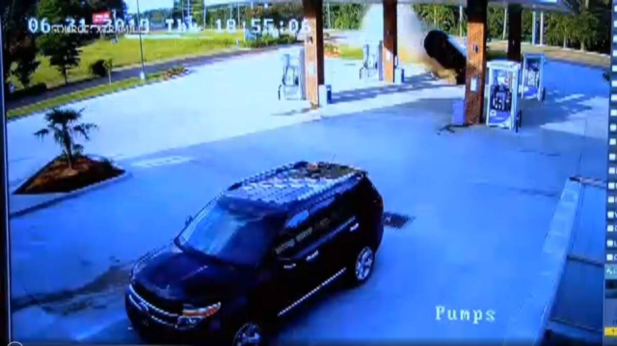 Surveillance video obtained by WLBT in Mississippi caught a woman's car skidding off the road, going airborne, striking a gas station sign and then landing next to one of the pumps Thursday, June 21, 2018.