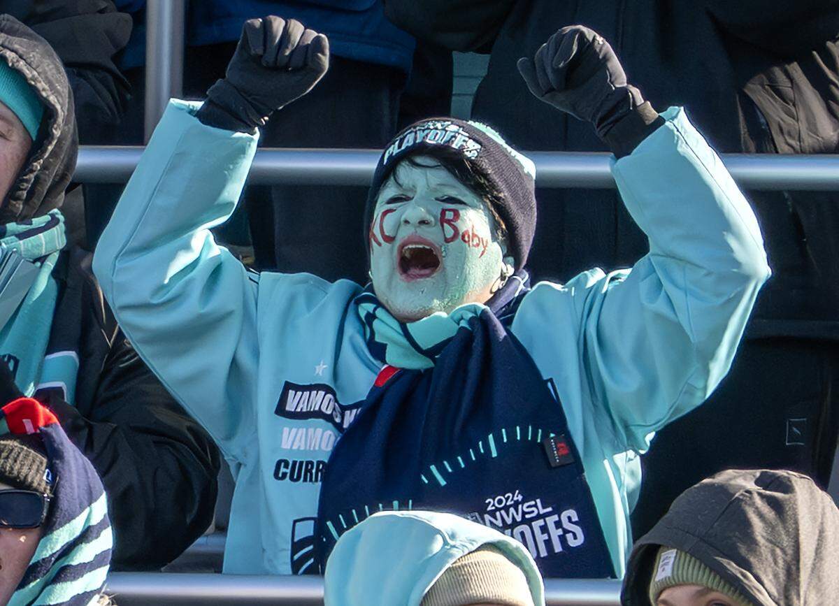 KC Current fan with teal face paint cheers from the stands during an NWSL quarterfinal playoff match at CPKC Stadium in Kansas City on Sunday, Nov. 9, 2025.
