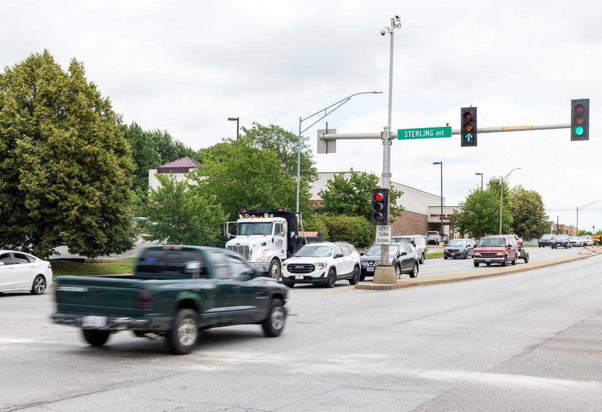 Vehicles drive through the South Sterling Avenue-East 23rd Street intersection in Independence on Tuesday following a police pursuit that ended in a crash at the intersection.