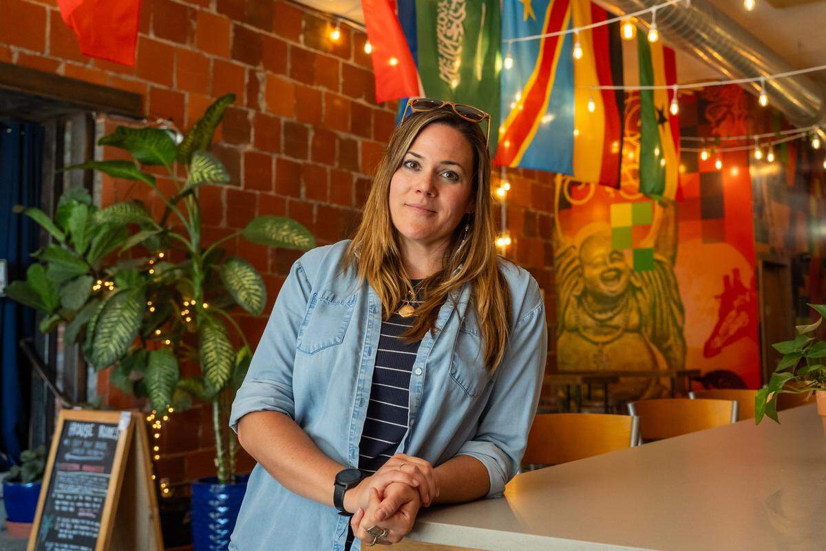 Owner Lara Gray of Casual Animal Brewing Co. on Monday, May 4, 2026. The owners are hanging flags for the participating World Cup national teams in anticipation of the event.