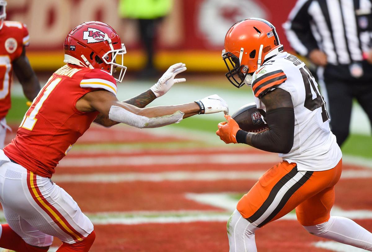 Cleveland Browns strong safety Karl Joseph intercepts a pass in the Kansas City Chiefs end zone in front of Kansas City Chiefs wide receiver Demarcus Robinson in the fourth quarter Sunday, January 17, 2021, at Arrowhead Stadium in Kansas City, Missouri.