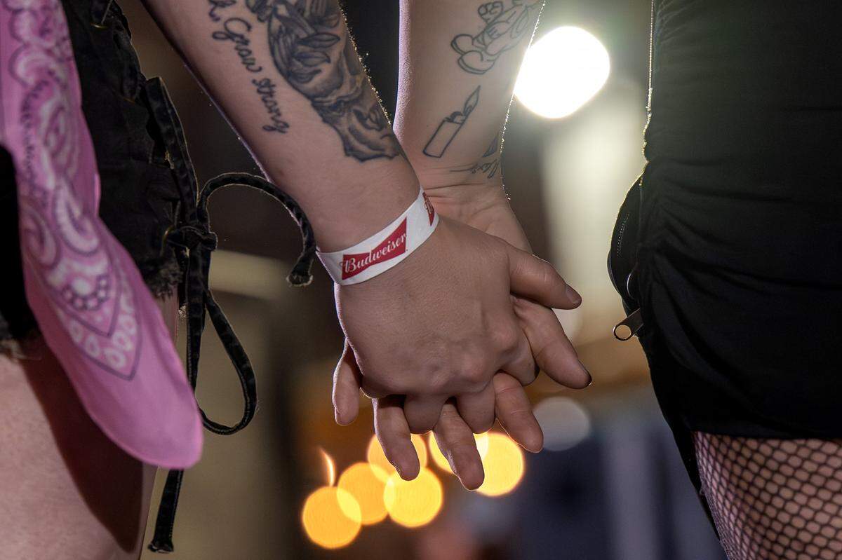 Guests hold hands during a Chappell Roan pre-party event at Incline on 9th on Thursday, Oct. 2, 2025, in Kansas City.