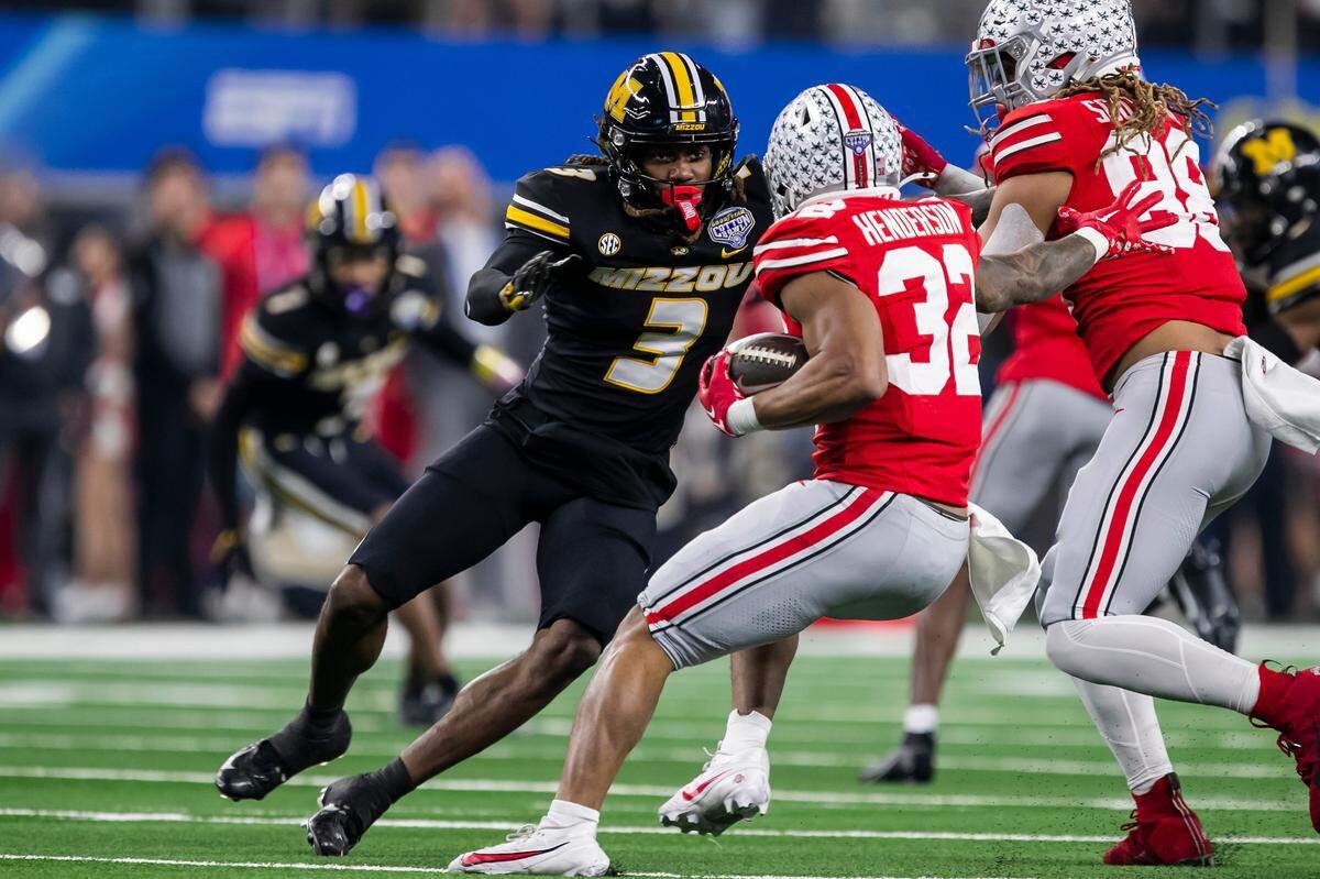 Missouri Tigers defensive back Sidney Williams Sr. (No. 3) chases down Ohio State running back TreVeyon Henderson during the 88th annual Cotton Bowl on Friday at AT&T Stadium in Arlington, Texas.